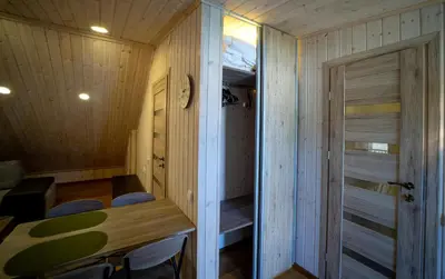 a small room with a table and chairs and a door at Kėdainiai Old town apartment in Kėdainiai