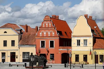 a group of buildings with a statue in front of them at Kėdainiai Old town apartment in Kėdainiai