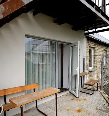a wooden bench sitting on the balcony of a building at Kėdainiai Old town apartment in Kėdainiai