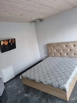 a bedroom with a bed and a picture on the wall at Kėdainiai Old town apartment in Kėdainiai