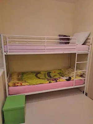 a bunk bed with pink bunk beds in a room at Comfortable Townhouse in Vilnius