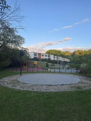 a playground in a park with a basketball hoop at Comfortable Townhouse in Vilnius