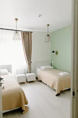 a bedroom with two beds and a window at Green Town in Vievis