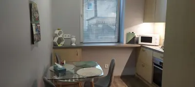 a small kitchen with a table and a microwave at Čepinskio in Kaunas