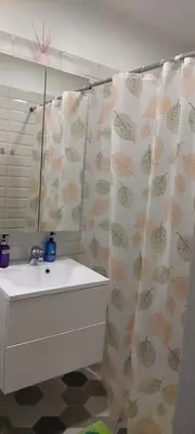 a bathroom with a sink and a shower curtain at Čepinskio in Kaunas