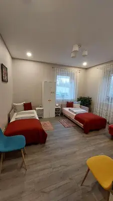 a bedroom with two beds and a table and chairs at Čepinskio in Kaunas