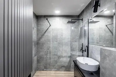a bathroom with a sink and a toilet and a shower at Urban center apartment in Vilnius