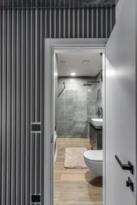 a bathroom with a shower and a toilet and a sink at Urban center apartment in Vilnius