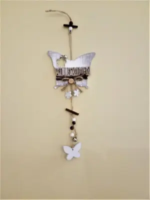 a butterfly orchid ornament hanging on a wall at Beautiful Apartment in the heart of Birstonas in Birštonas