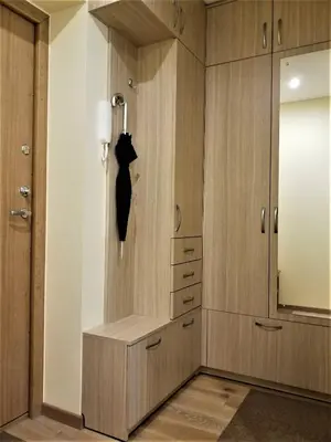 a dressing room with wooden cabinets and a black dresser at Beautiful Apartment in the heart of Birstonas in Birštonas