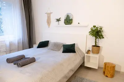 a bedroom with a bed with two pillows on it at Visaginas Flat White in Visaginas