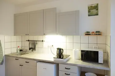 a kitchen counter with a microwave and a sink at Visaginas Flat White in Visaginas