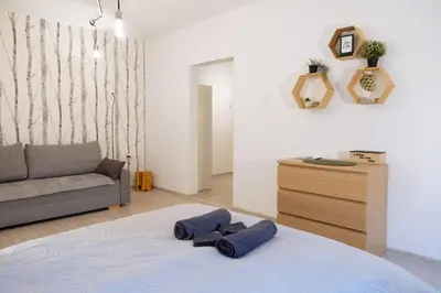 a living room with a bed and a couch at Visaginas Flat White in Visaginas