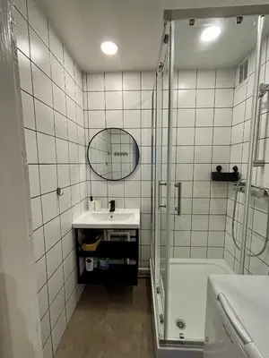 a bathroom with a shower and a sink and a mirror at Visaginas Flat White in Visaginas