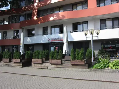 a building with potted plants in front of it at Amazing Snow Apartments in Druskininkai