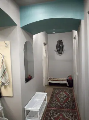 a hallway with a room with a green ceiling at HelloVilniusHostel in Vilnius