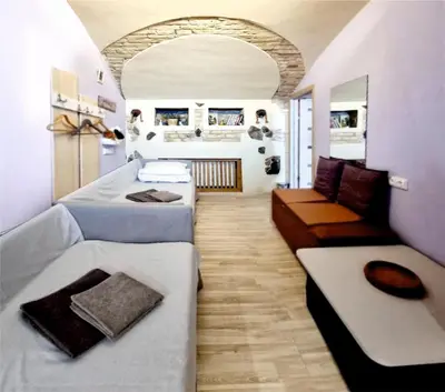 a room with two beds and a couch at HelloVilniusHostel in Vilnius