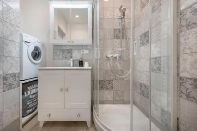 a bathroom with a shower and a sink and a tub at HaPPy Inn Rich Studio, Self Check-In-24x7,Parking-in-the-underground-Garage in Vilnius