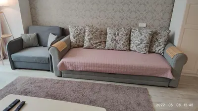 a couch and a chair in a living room at HaPPy Inn Rich Studio, Self Check-In-24x7,Parking-in-the-underground-Garage in Vilnius