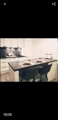 a kitchen with a table and two chairs in it at HaPPy Inn Rich Studio, Self Check-In-24x7,Parking-in-the-underground-Garage in Vilnius
