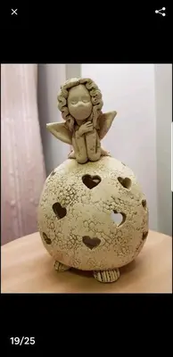 a small angel sitting on top of a vase at HaPPy Inn Rich Studio, Self Check-In-24x7,Parking-in-the-underground-Garage in Vilnius