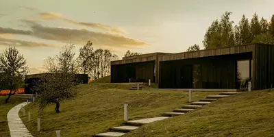 a building on a hill with stairs leading to it at Wakepond atostogų slėnis in Anykščiai