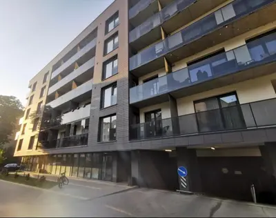 a large building with balconies on the side of it at Brand new apartment in Vilnius in Vilnius