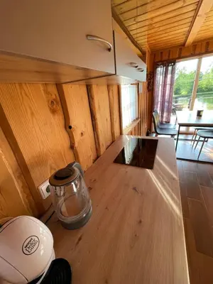 a inside view of a kitchen in a tiny house at Gintaro pirtelė in Lazdijai