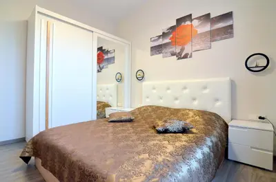 a bedroom with a large bed and a mirror at Royal Resident in Druskininkai