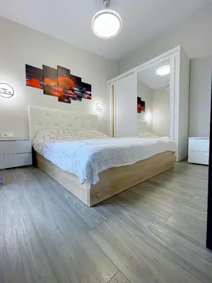 a bedroom with a bed and a large mirror at Royal Resident in Druskininkai