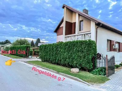 a house with a sign on the side of the road at Royal Resident in Druskininkai