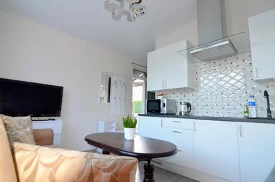 a kitchen with a table and a counter top at Royal Resident in Druskininkai