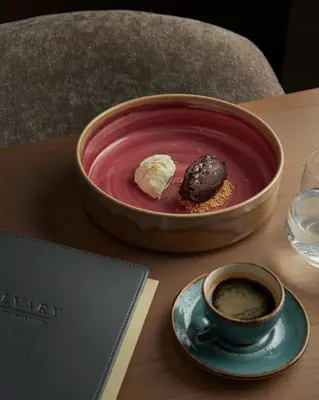 a bowl of soup and a cup of coffee on a table at CALVARY Hotel & Restaurant Vilnius in Vilnius