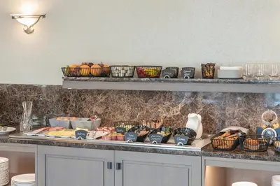 a kitchen with a counter with plates and bowls of food at CALVARY Hotel & Restaurant Vilnius in Vilnius