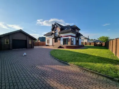 a house with a brick driveway in front of a house at Villa MAG in Druskininkai