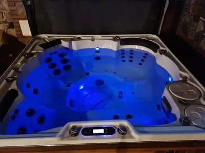a blue and white tub in a table with remotes at Villa MAG in Druskininkai