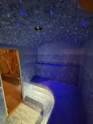 a blue room with a bath tub with blue lights at Villa MAG in Druskininkai