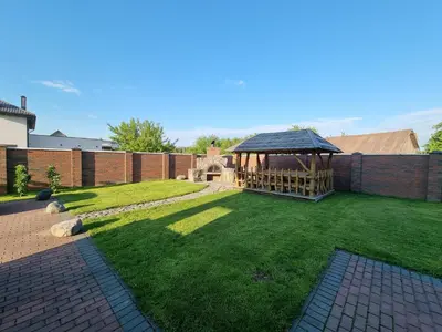 a garden with a gazebo in a yard at Villa MAG in Druskininkai