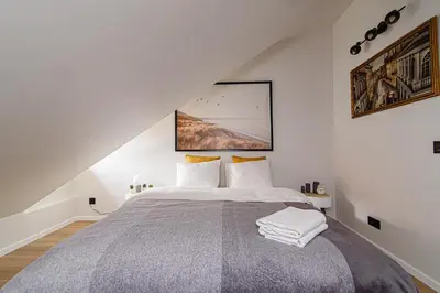 a bedroom with a large bed in a attic at Zydu str two bedrooms Apartment by URBAN RENT in Vilnius