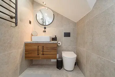 a bathroom with a sink and a toilet and a mirror at Zydu str two bedrooms Apartment by URBAN RENT in Vilnius
