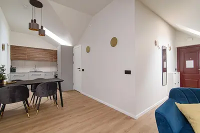 a kitchen and living room with a table and chairs at Zydu str two bedrooms Apartment by URBAN RENT in Vilnius