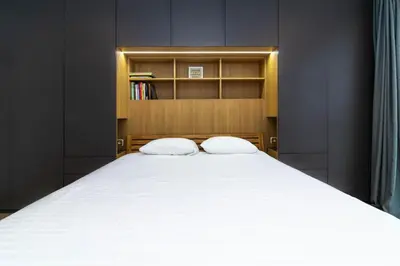 a bedroom with a large bed with two pillows at Sunny Center Apt, Covered Parking, Balcony & Self Check-in in Kaunas