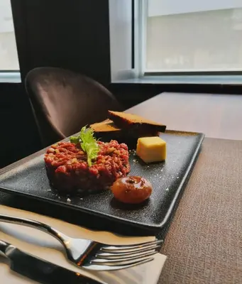 a plate of food with meat and bread and cheese at Brut Wine Hotel in Zarasai