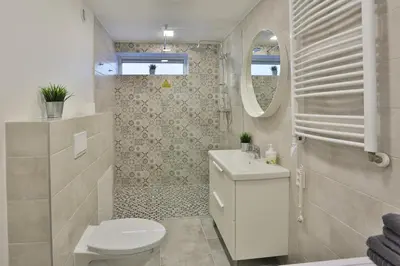 a bathroom with a toilet and a sink and a mirror at River Park apartments Ukmerge in Ukmergė