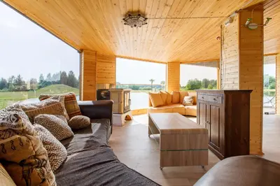 a living room with a couch and a table at Brazylija VIP vasarnamis in Kryliai