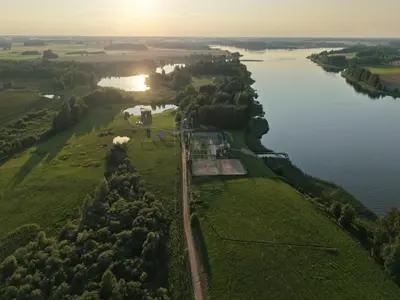 an aerial view of a river with a farm at Brazylija VIP vasarnamis in Kryliai