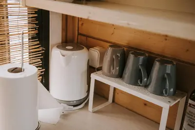 a group of pots and pans sitting on a shelf at Vienkiemio oazė - Skandinaviškas namelis su vaizdu į tvenkinį in Galvokai