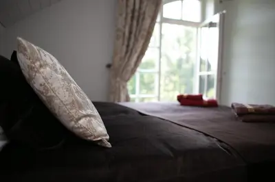 a pillow sitting on top of a bed with a window at Domingo vila in Krosna