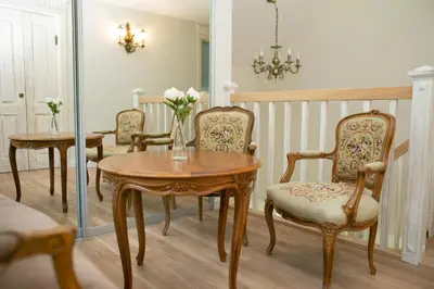 a dining room with a table and chairs and a mirror at Domingo vila in Krosna