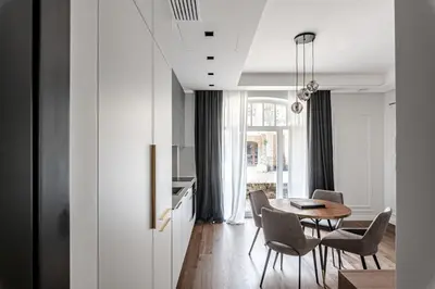 a kitchen and dining room with a table and chairs at Luxurious Apartment in Vilnius Old Town by Reside Baltic in Vilnius